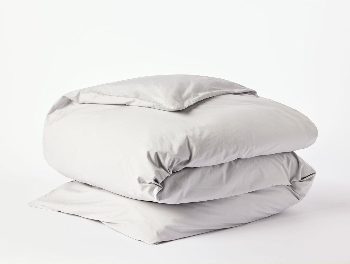 Coyuchi Refined Percale duvet cover folded neatly, shown in silver-grey percale cotton.