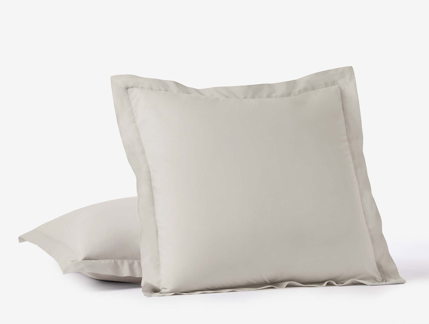 Close-up of Coyuchi Refined Percale sham in pale grey with tailored flange border.