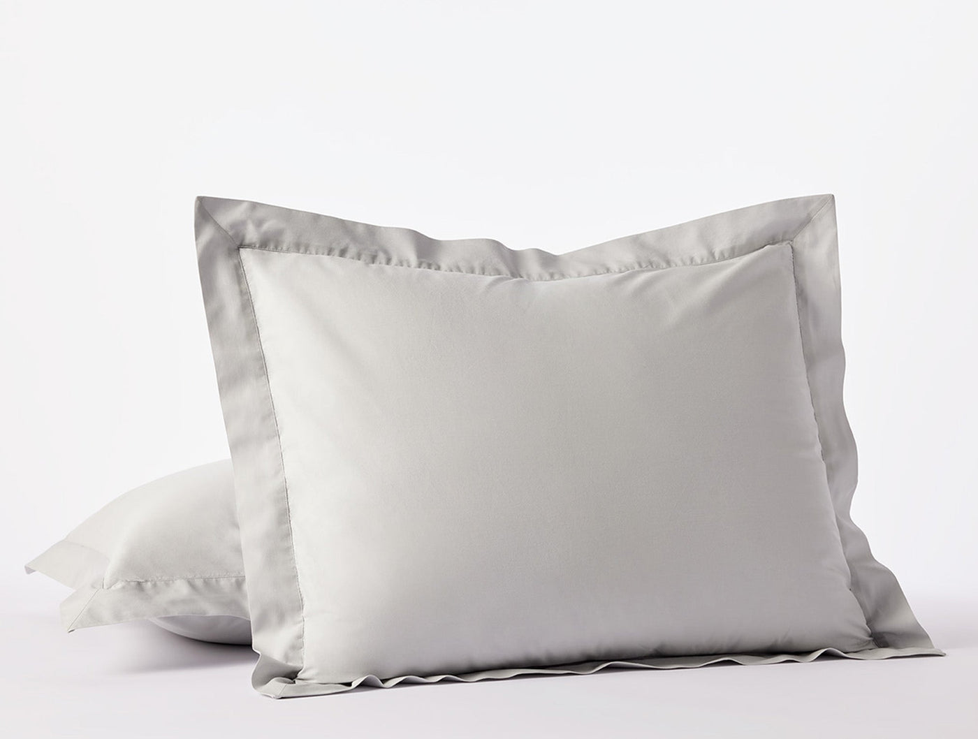 Two-tone white and silver grey euro shams stacked, showing contrast flange border detail.