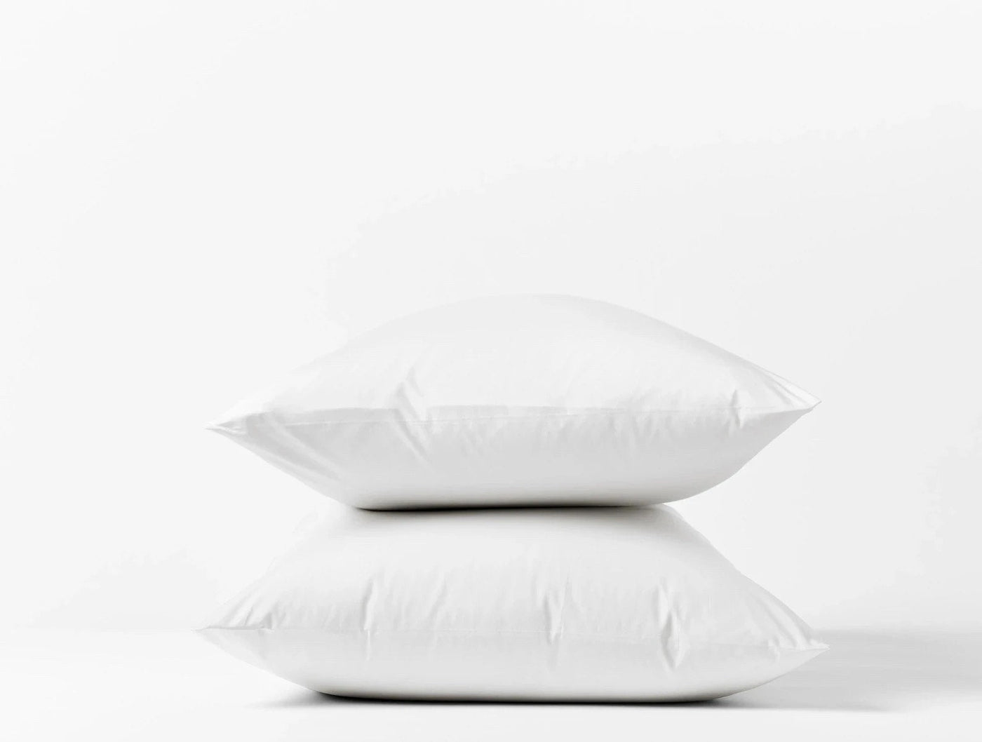 Coyuchi Heritage Percale pillowcase pair in white, two pillows stacked on white background.