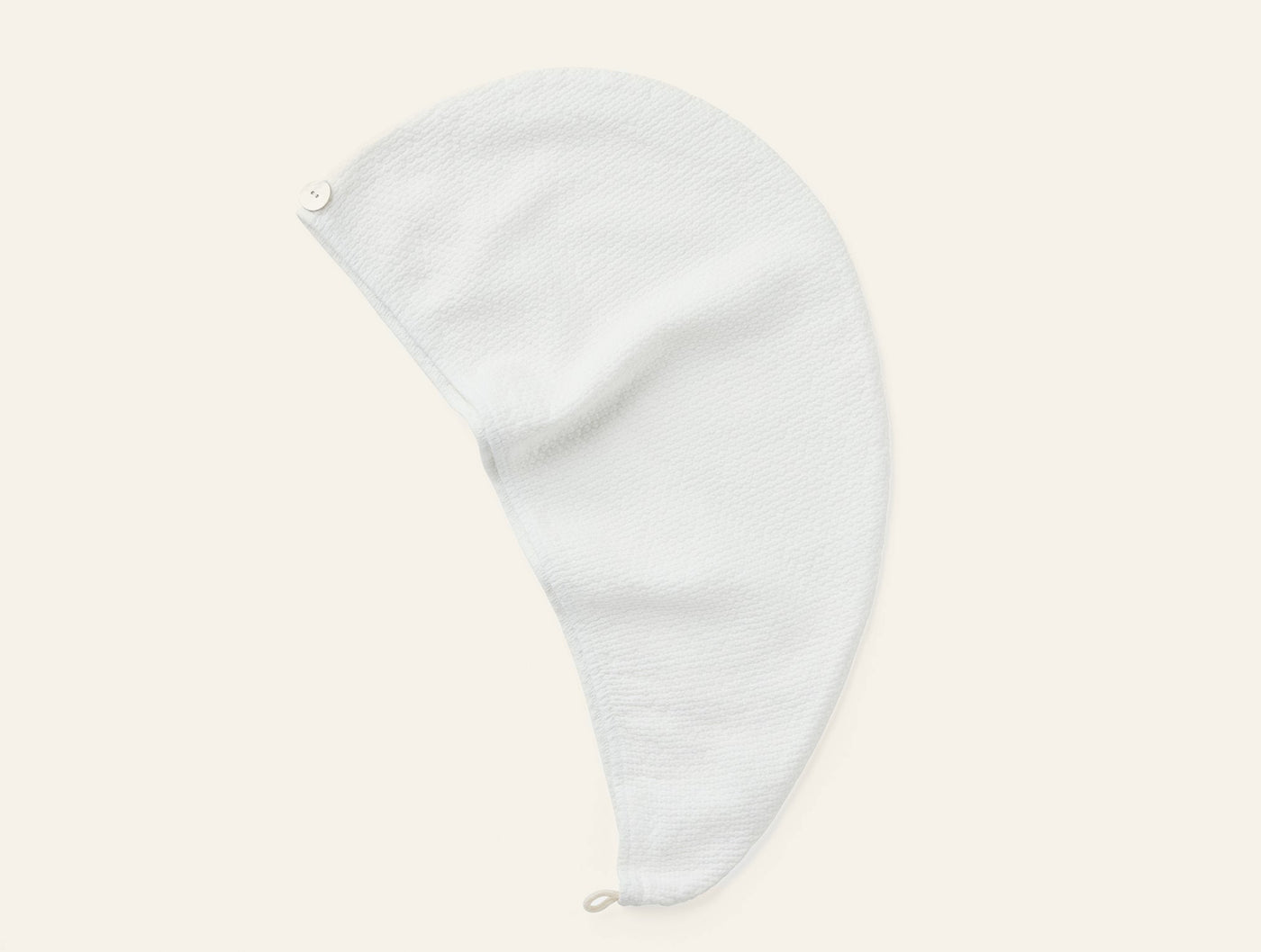 Coyuchi Adriatic hair wrap in white, flat lay showing loop closure and textured weave.