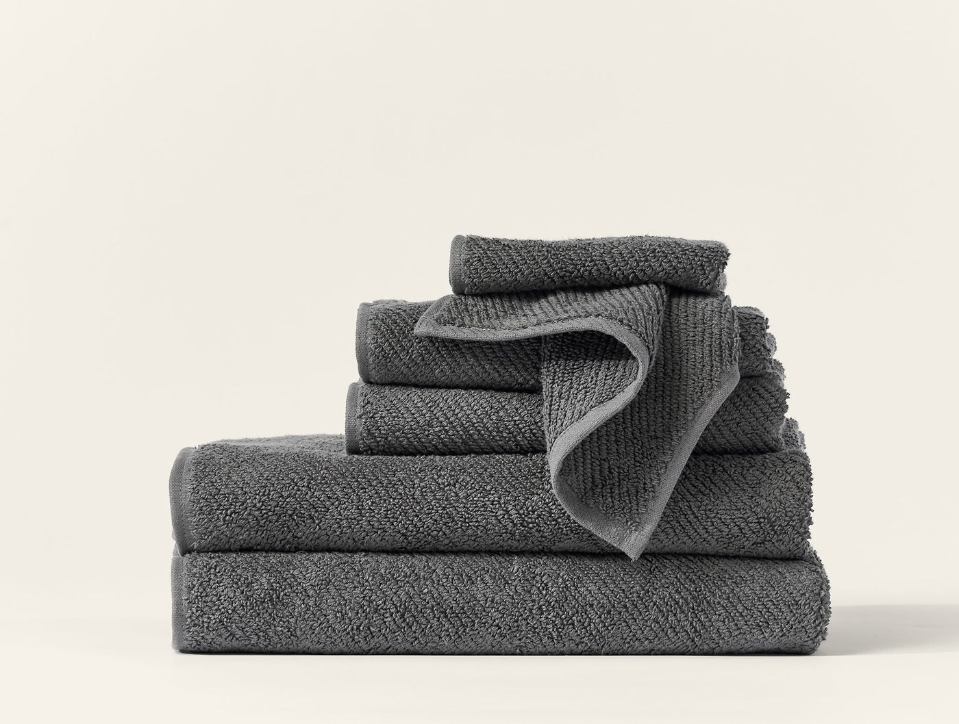 Coyuchi Air Weight wash cloth set stacked in slate grey, showing textured weave detail.