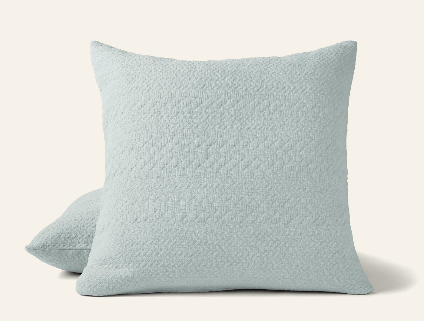 Coyuchi Angeles Matelasse pillow sham in mist blue with herringbone quilted texture.