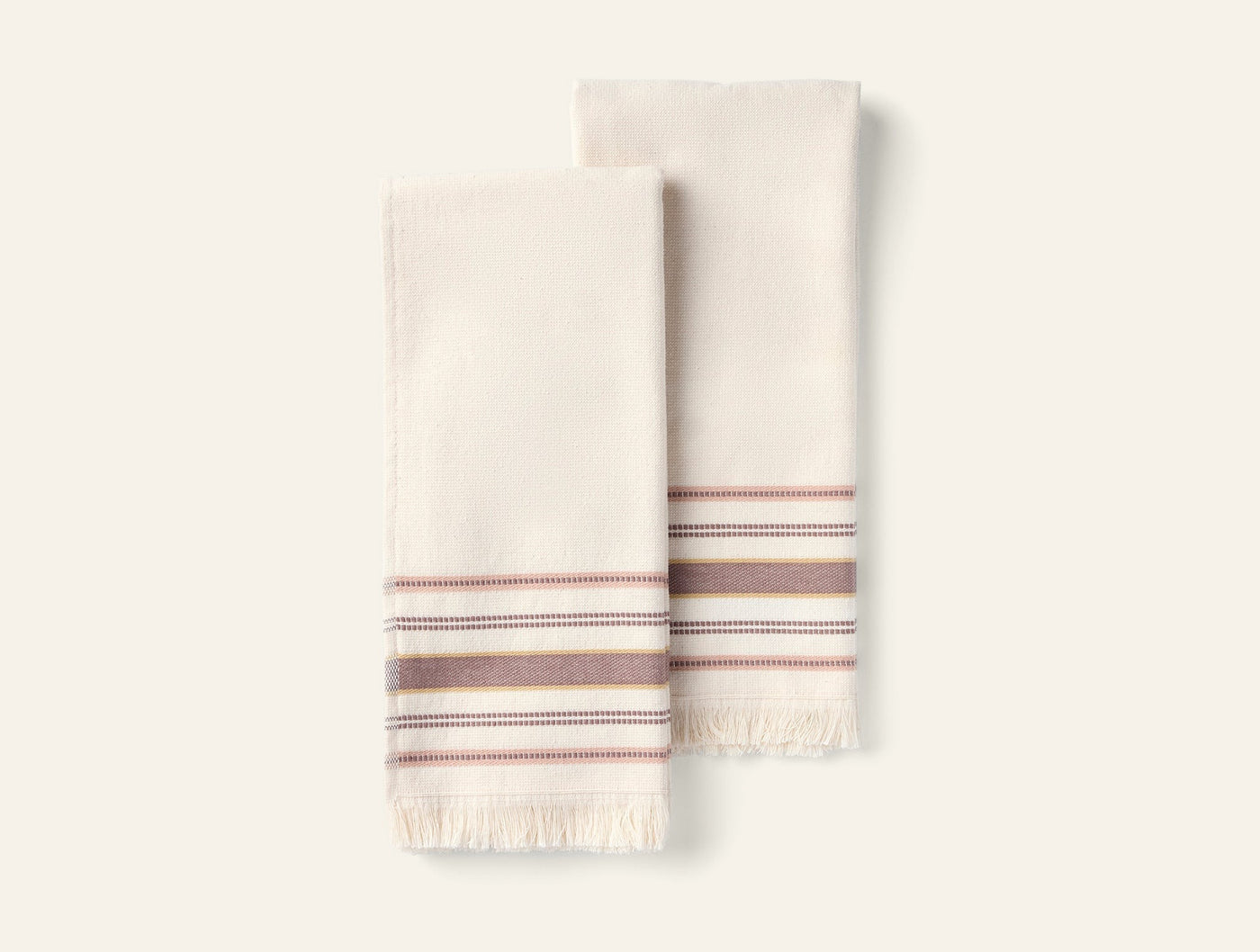 Coyuchi Aptos hand towel pair in ivory with red and grey stripe detail and fringe hem.