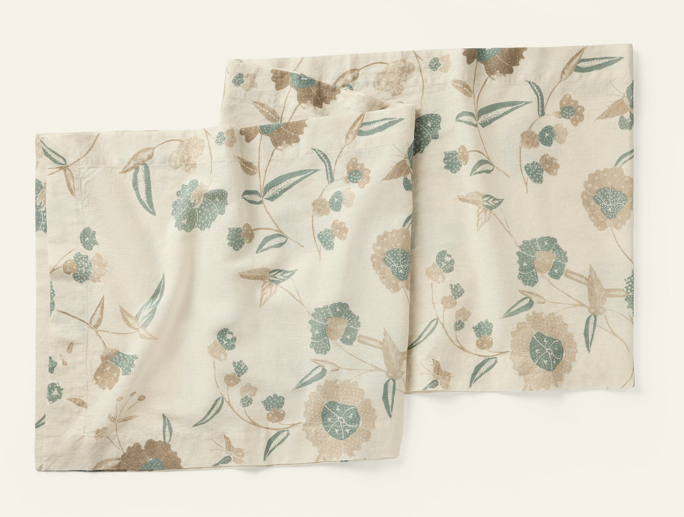 Coyuchi Aurora Print table runner in ivory with teal and taupe floral botanical pattern.