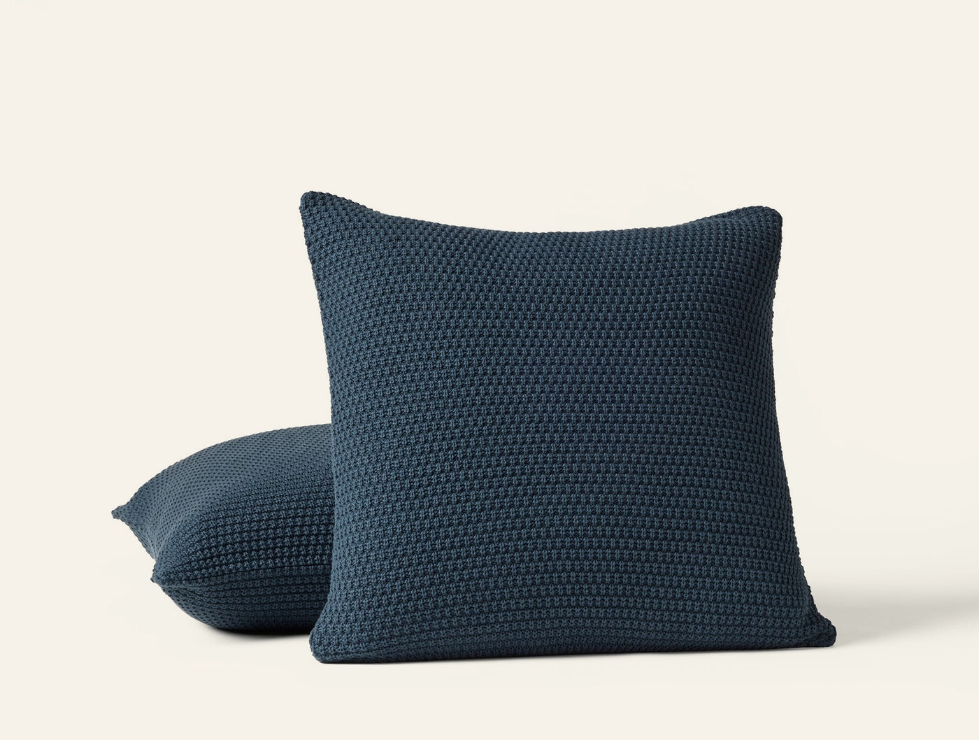 Coyuchi Avalon Knit pillow covers in navy, showing chunky knit texture, two sizes.