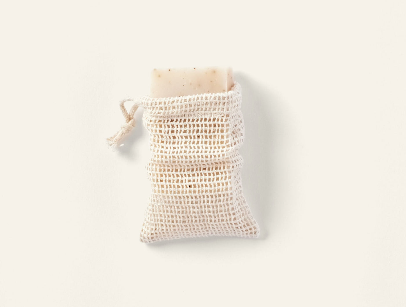 Coyuchi Bare soap bag in natural cotton mesh with drawstring closure.