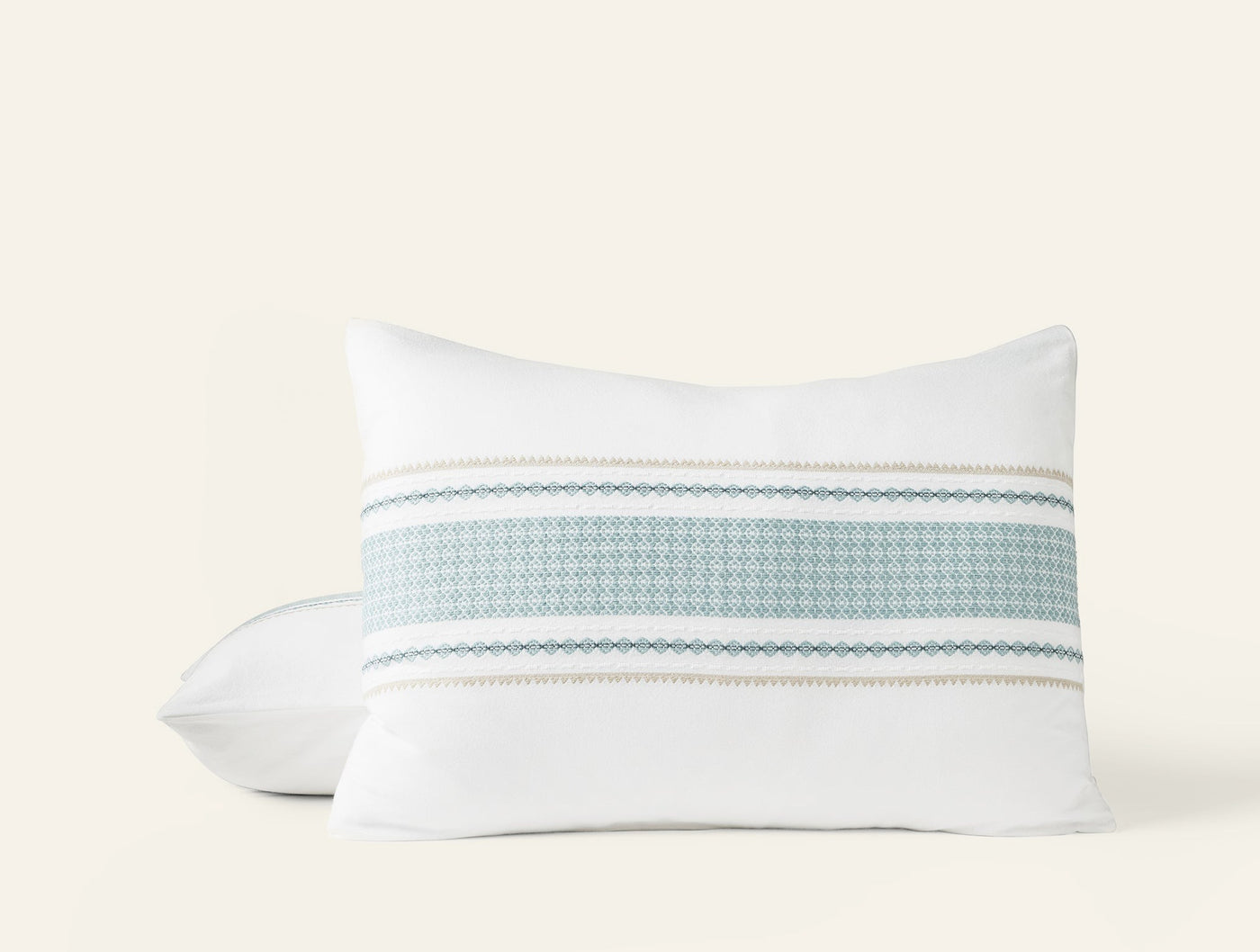 Coyuchi Cabrillo pillow sham in white with woven aqua and sand stripe detail.