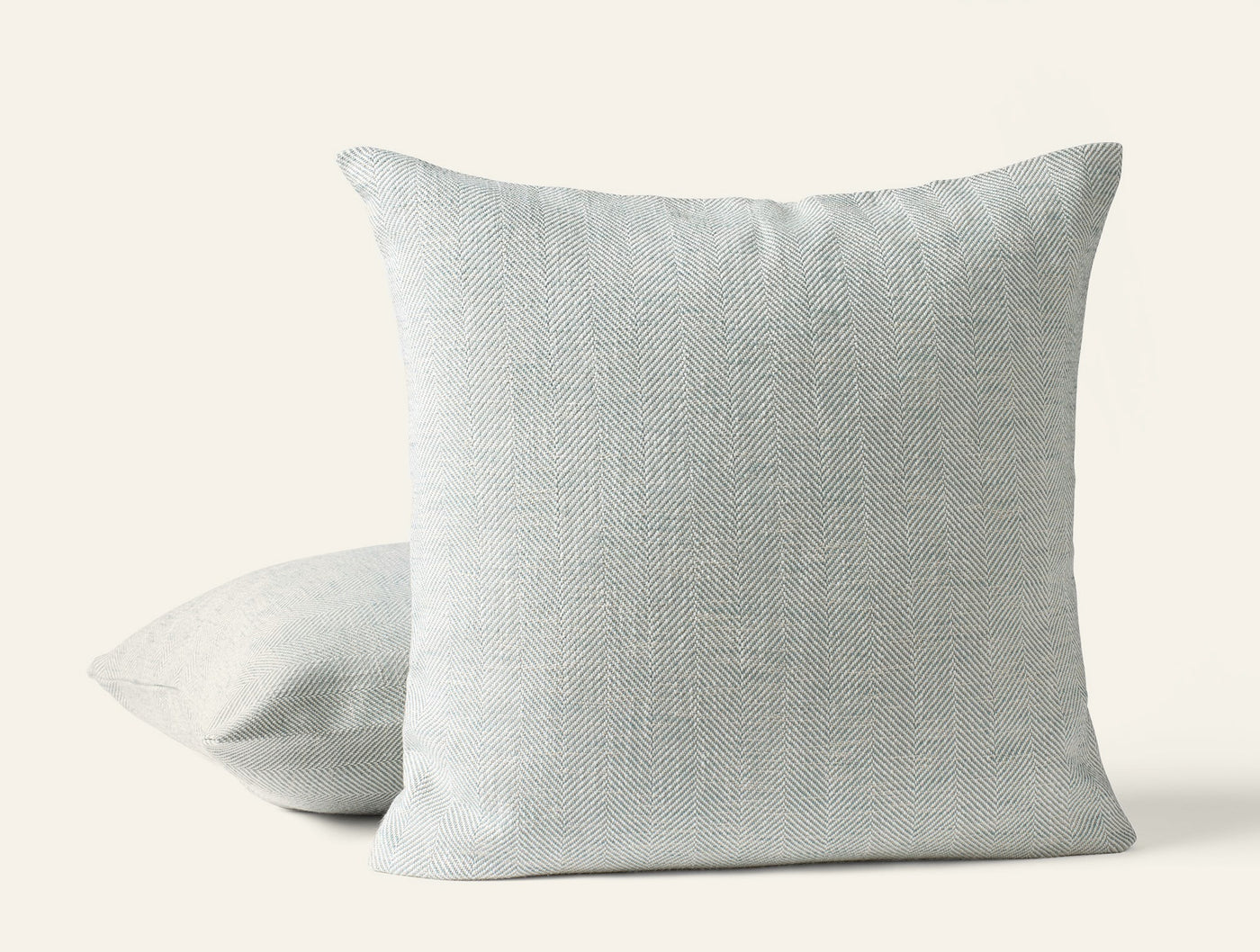 Two Coyuchi Canyon linen throw pillow covers in mist, showing front and angled side views.