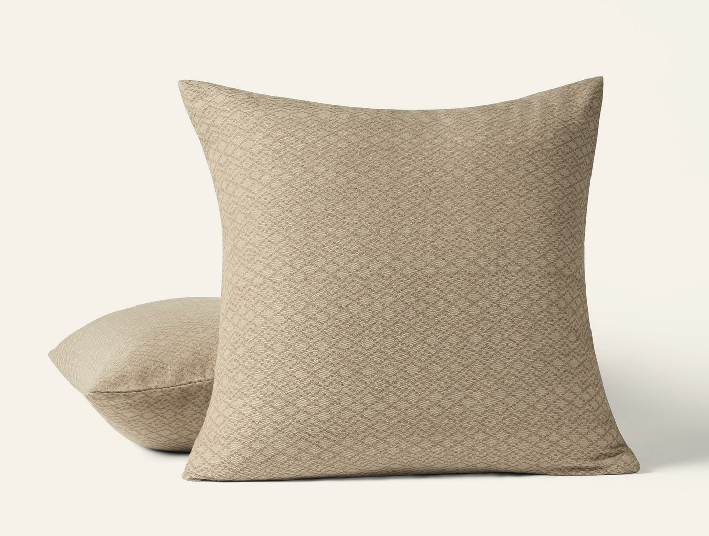 Close-up of two Capitola pillow shams in champagne with a diamond weave texture pattern.