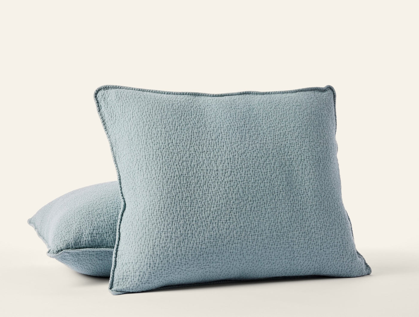 Pair of Coyuchi Cascade Matelassé shams in dusty blue with textured boucle surface.