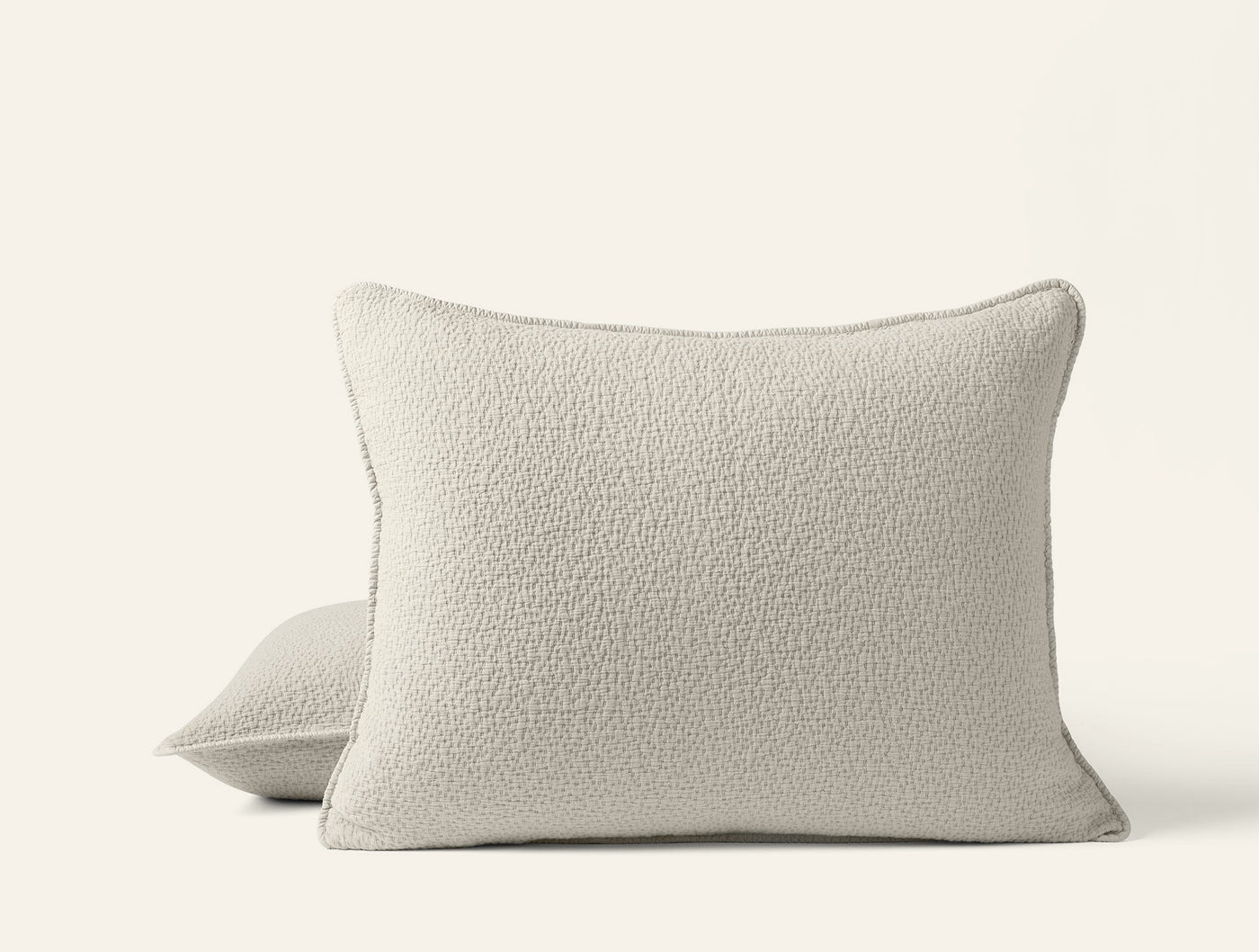 Ivory boucle-textured matelasse pillow shams, pair shown front and back views.