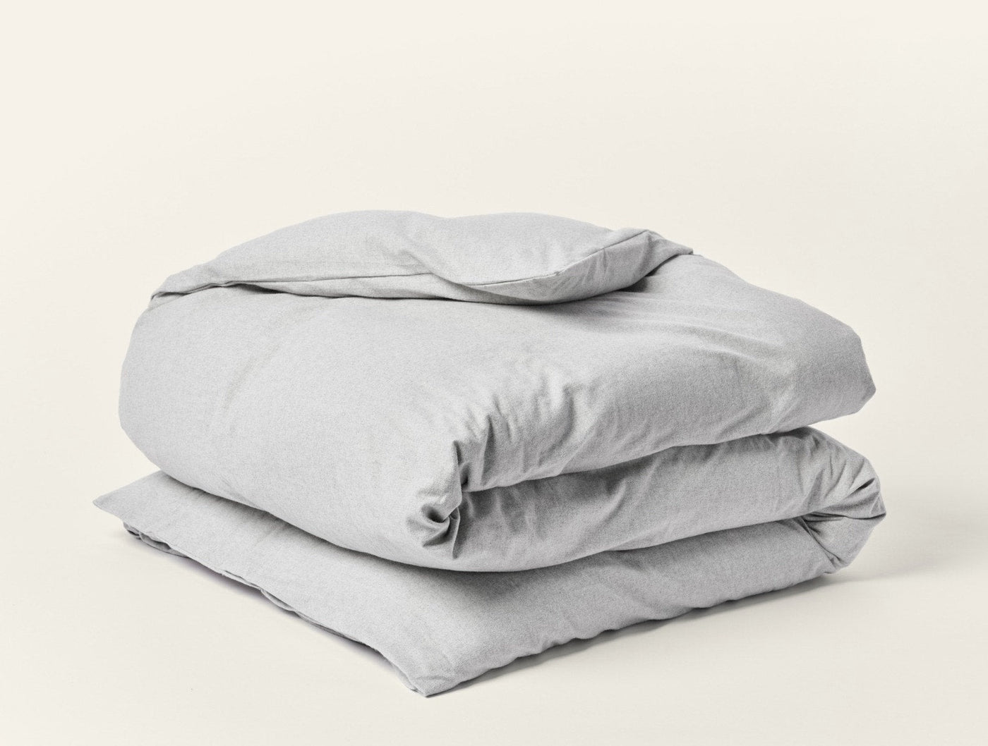 Close-up of folded Coyuchi Cloud Brushed Flannel duvet cover in heathered grey.
