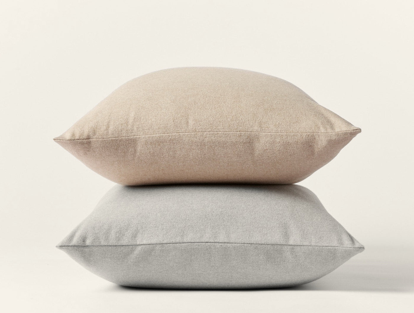 Two stacked oatmeal brushed flannel pillow shams against a white background.