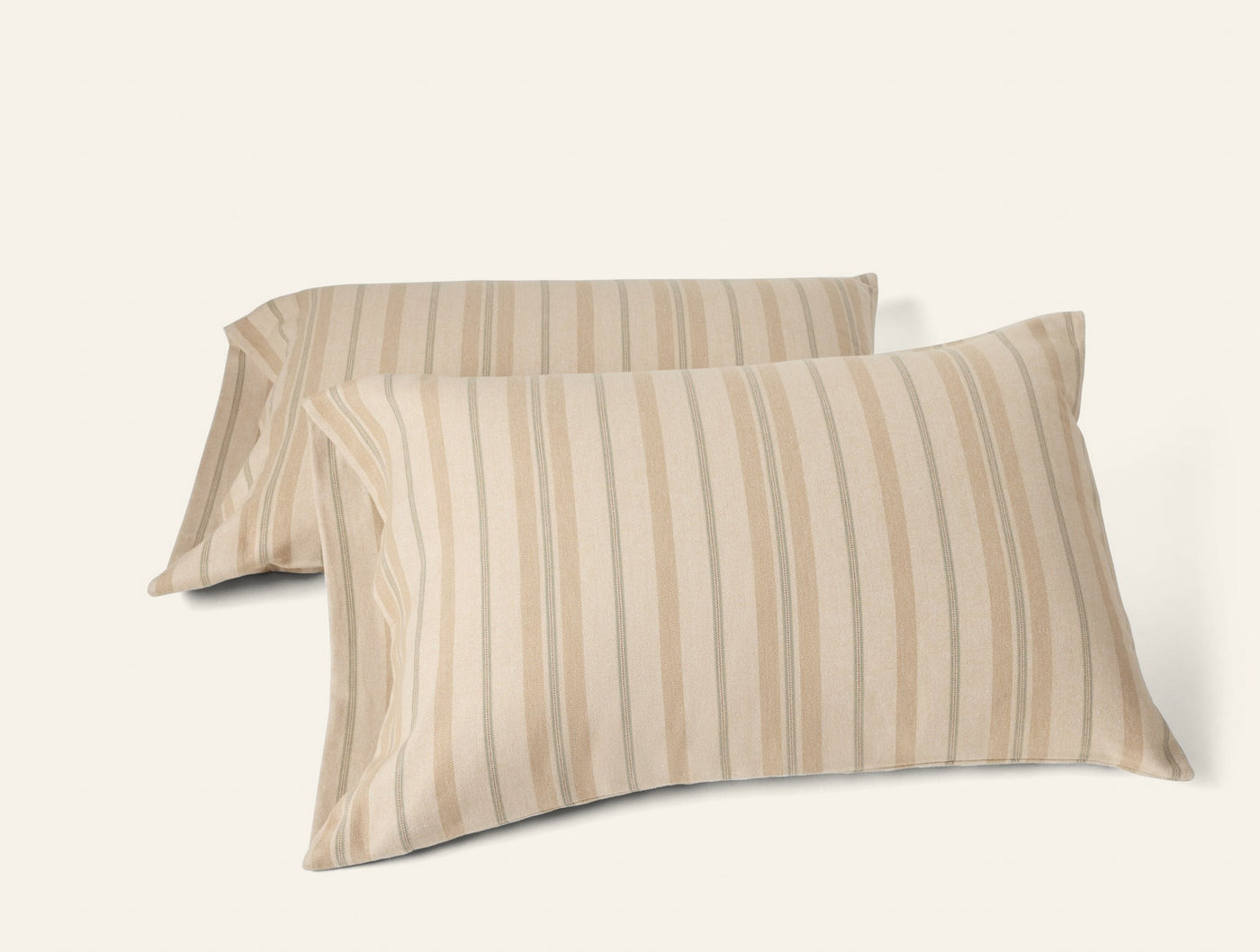 Pair of sandy stripe flannel pillowcases stacked at an angle on white background.