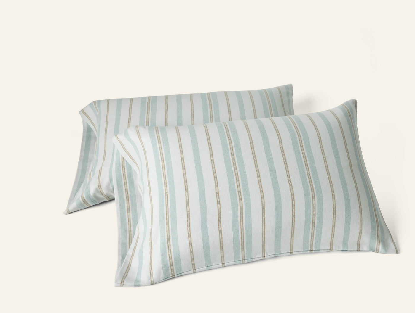 Pair of Coyuchi Cloud Brushed Flannel pillowcases in seafoam and sand stripe pattern.