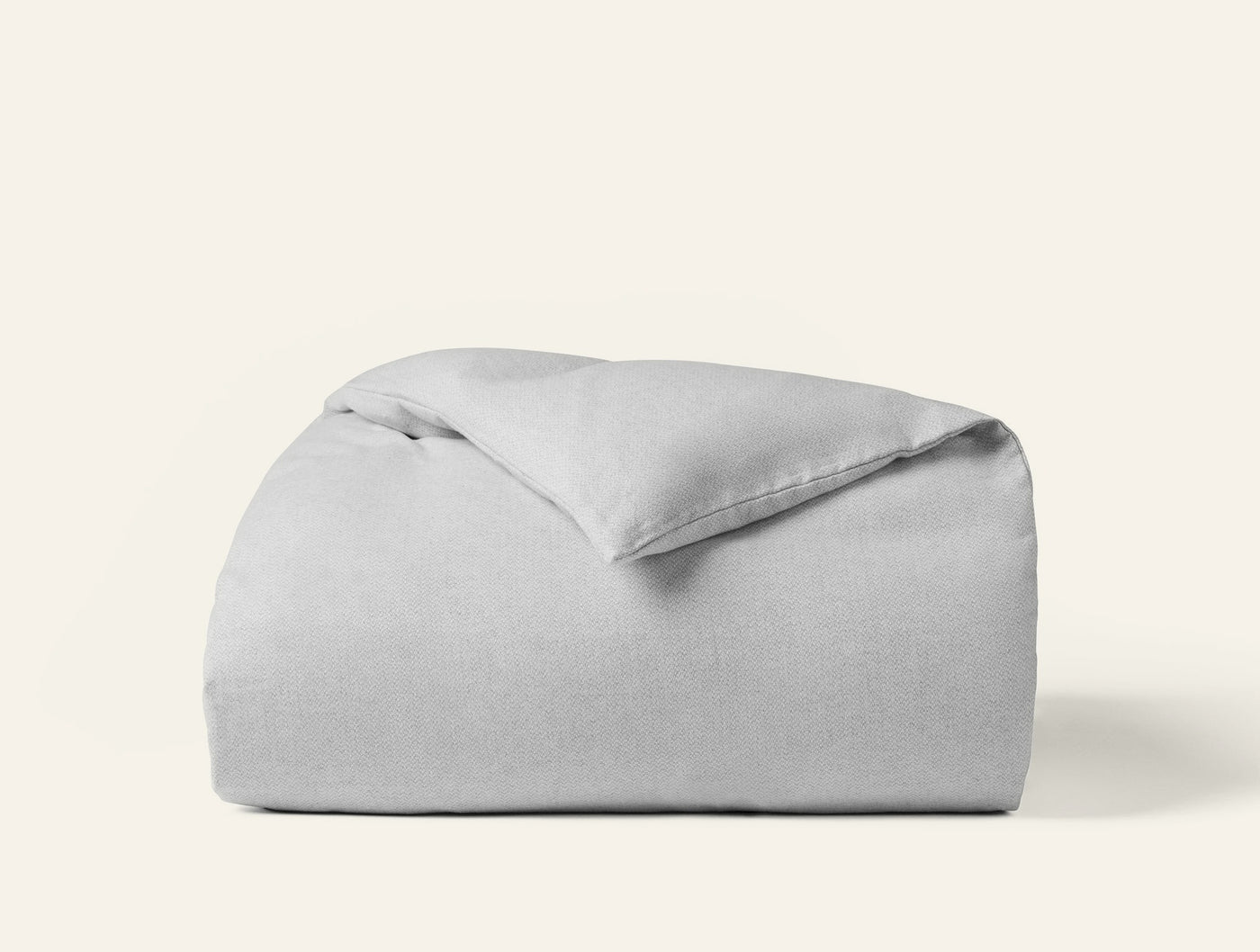 Close-up of folded silver grey flannel duvet cover with soft brushed texture.
