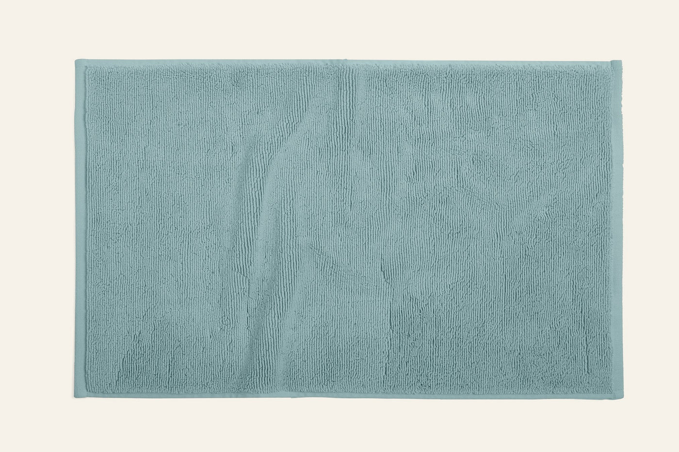 Coyuchi Cloud Loom bath rug in seafoam, overhead flat lay showing plush terry texture.