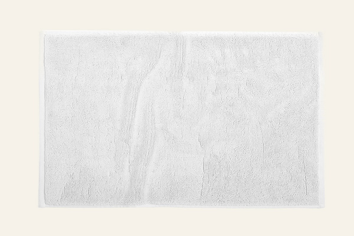 Coyuchi Cloud Loom bath rug in white, shown flat with plush terry texture.