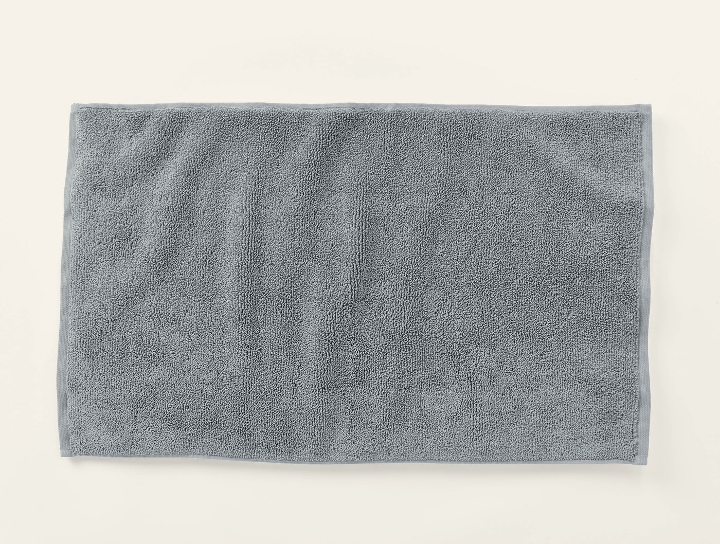 Coyuchi Cloud Loom bath rug in slate, overhead flat lay showing plush terry texture.