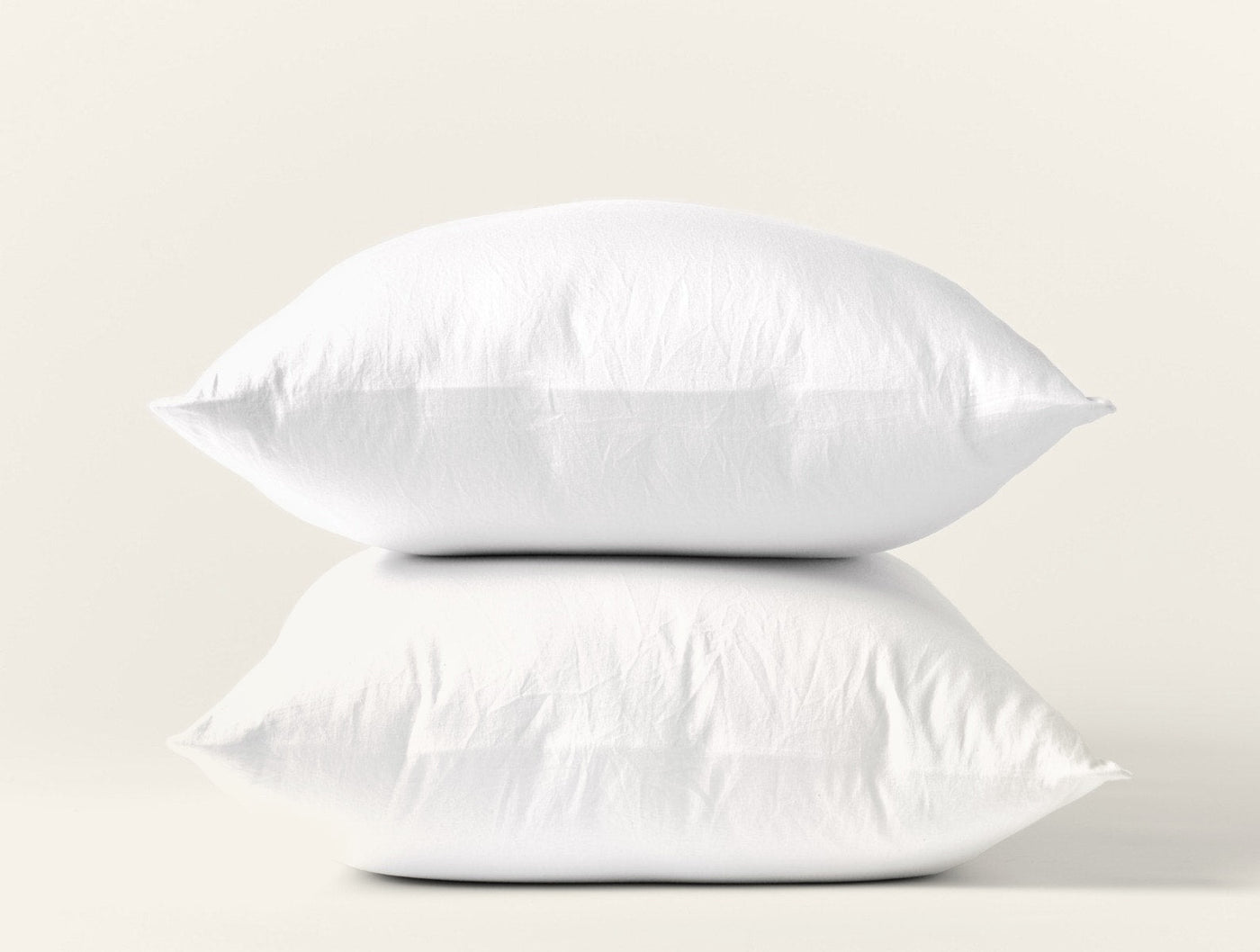 Coyuchi Cloud Soft Sateen pillowcase pair in white, two pillows stacked against white background.