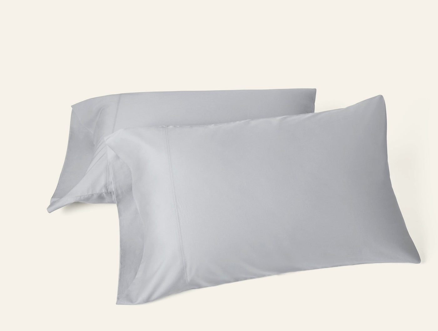 Two Coyuchi Cloud Soft Sateen pillowcases in silver, smooth finish, stacked pair view.