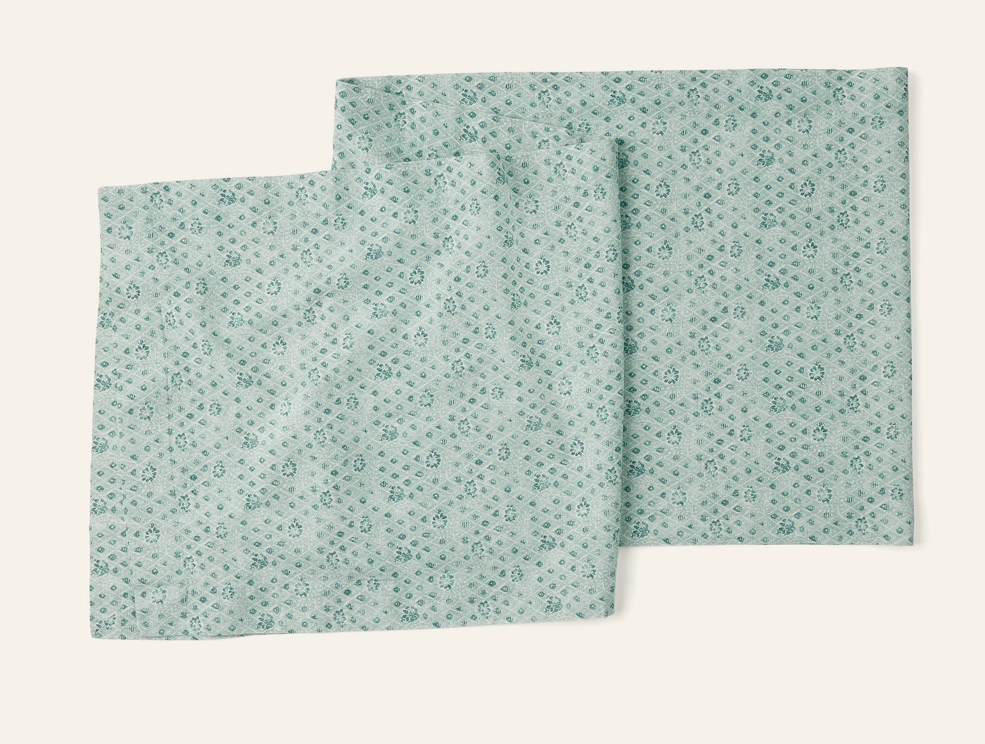 Close-up of Coyuchi Coral Bell Print runner in seafoam with scattered floral motifs.