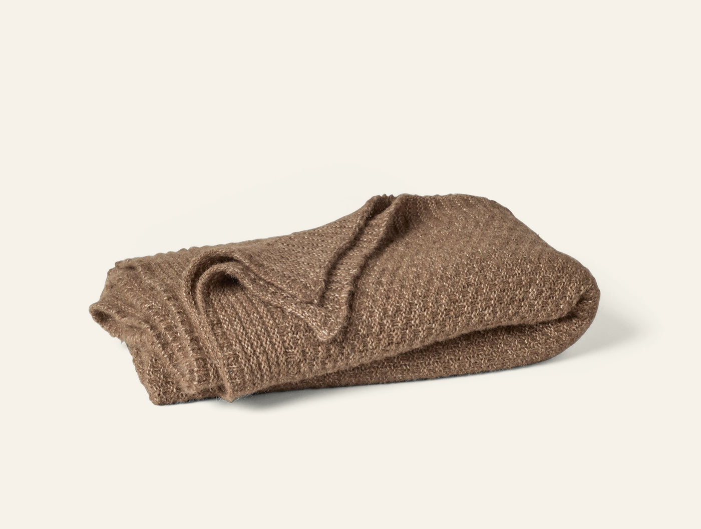 Coyuchi Cordillera Alpaca Cotton Knit throw in camel, folded to show waffle texture.