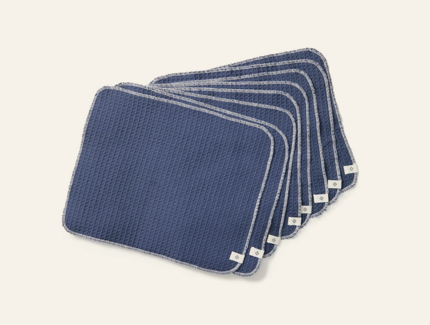 Coyuchi Conserve navy waffle-weave paperless towel set of eight, fanned display.
