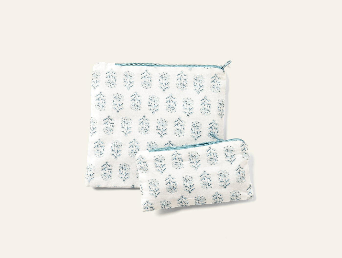 Coyuchi Conserve snack bag set in white with teal block-print floral pattern, two sizes shown.