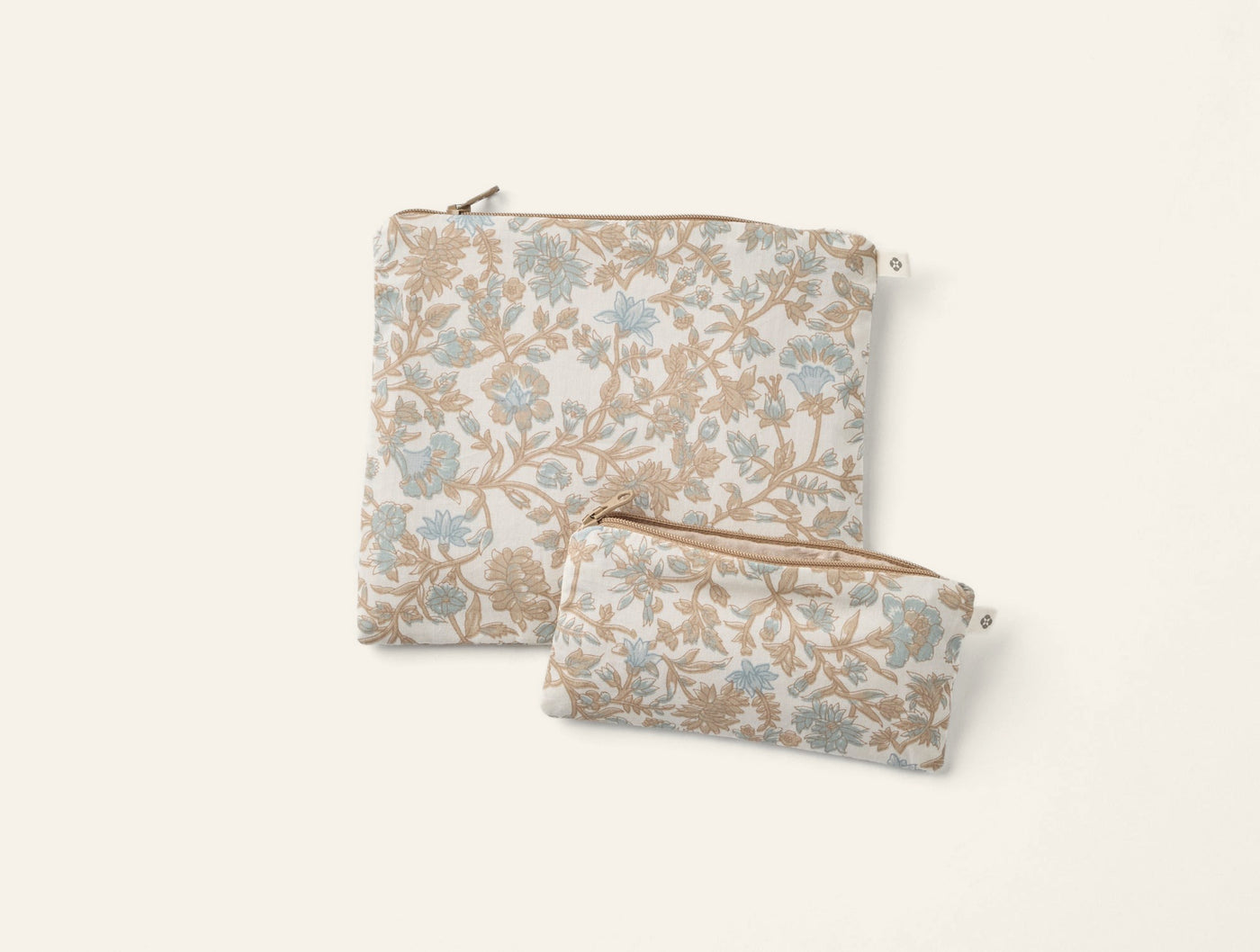 Two Coyuchi Conserve snack bags in floral blue and tan print, large and small sizes.