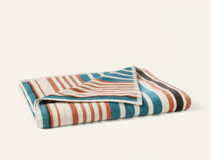 Photo of the Dawn Stripe | Beach Towel ensemble.