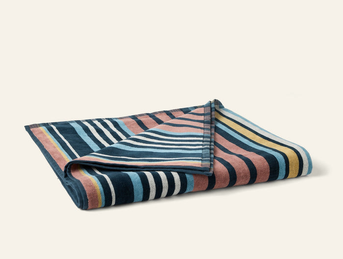 Photo of the Dawn Stripe | Beach Towel ensemble.