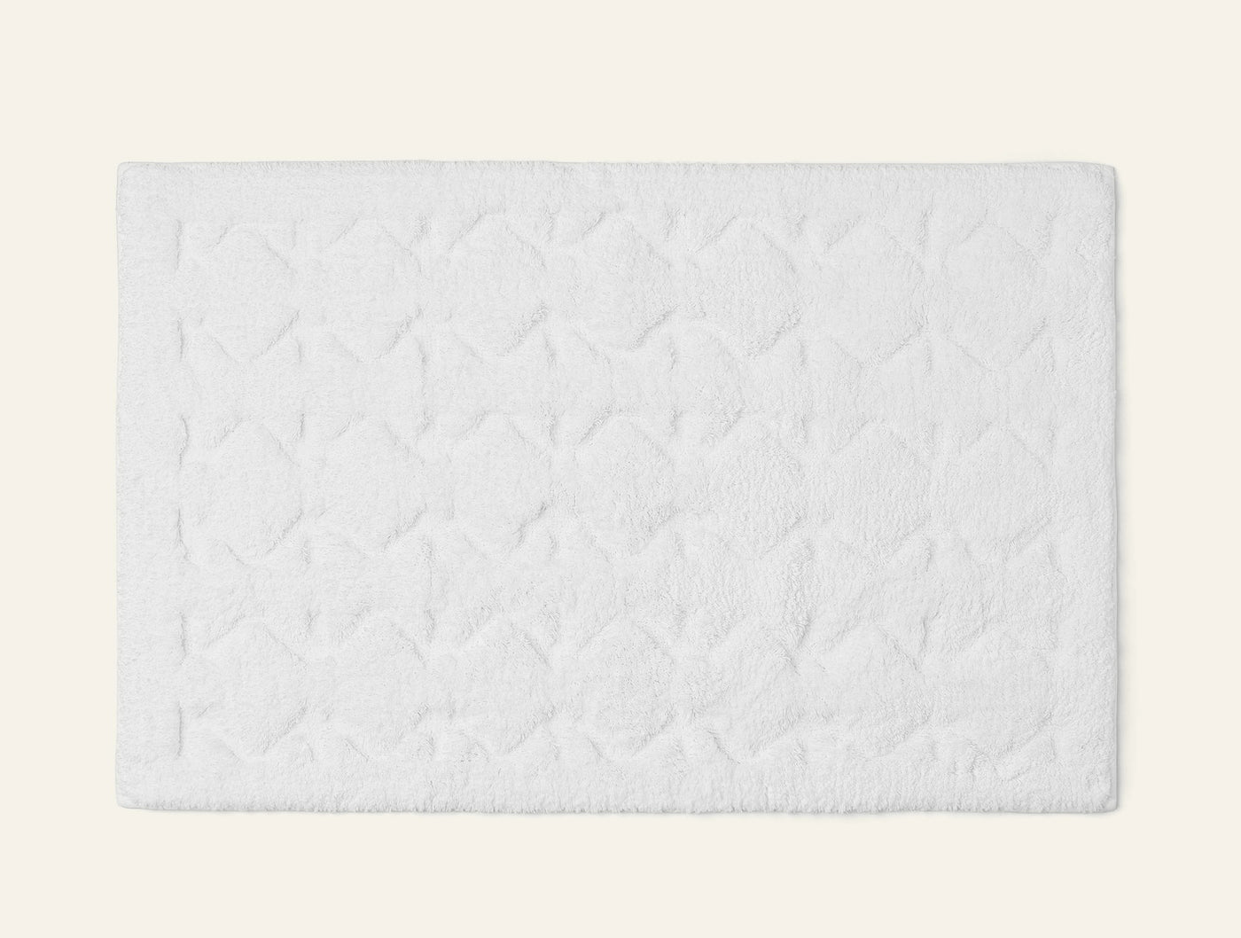 Coyuchi Diamond Shag bath rug in white with tufted diamond pattern texture.