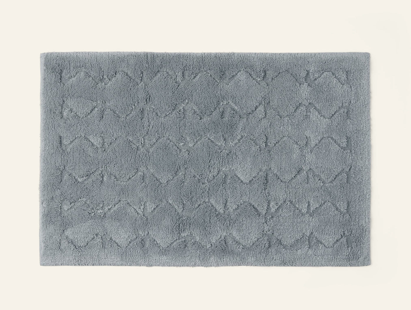 Coyuchi Diamond Shag bath rug in slate blue, overhead view showing tufted diamond pattern.