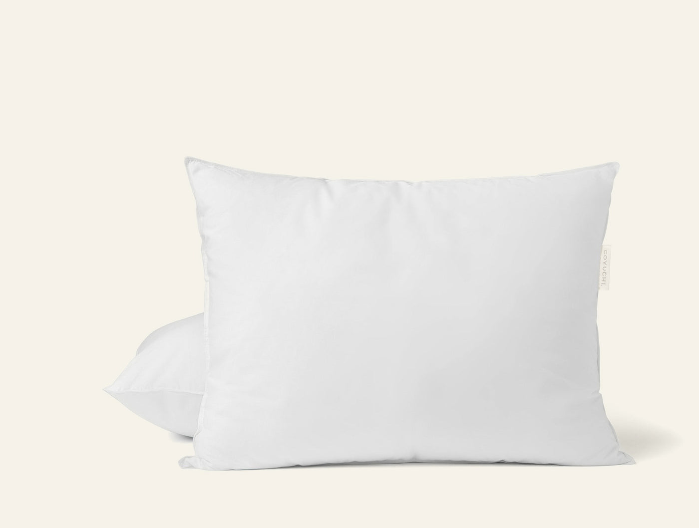 Coyuchi Down Pillow Insert, two white pillows stacked against a light grey background.