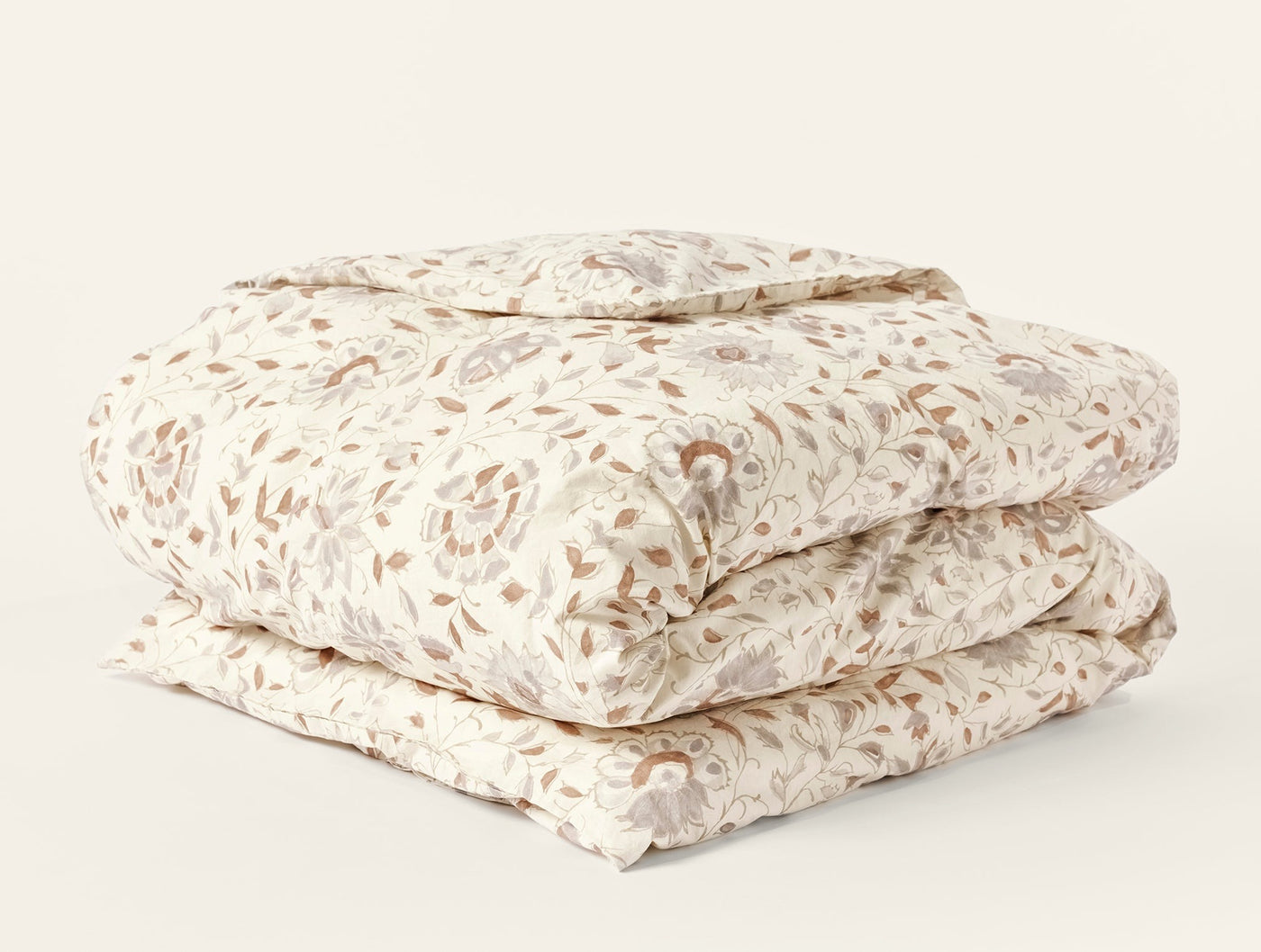 Folded Flora Print duvet cover showing taupe and ivory floral pattern across full surface.