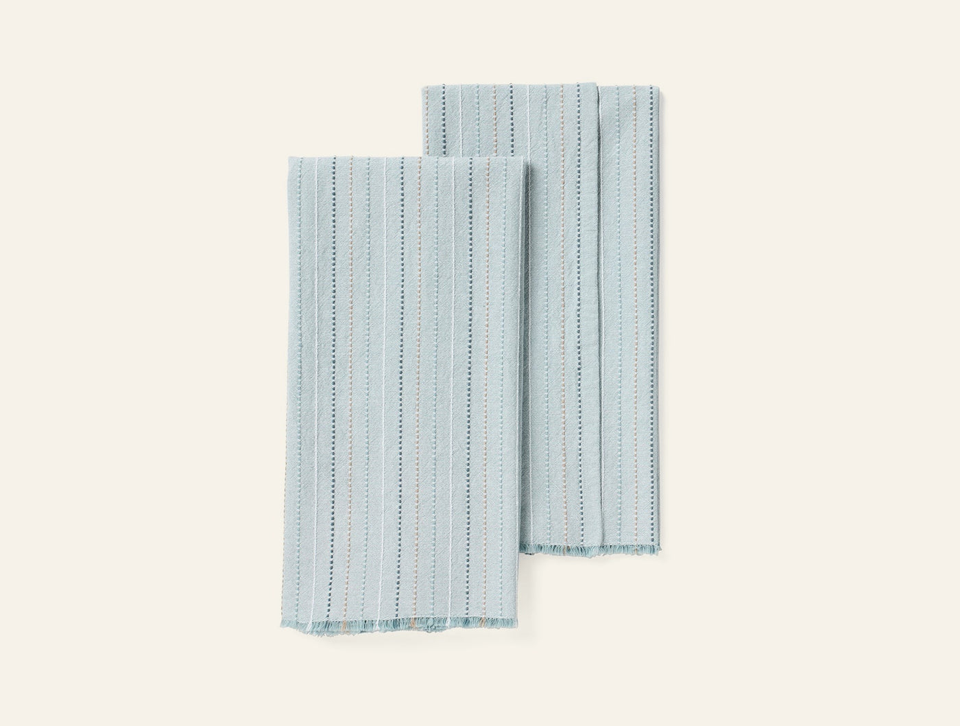 Pair of seafoam hand towels with vertical stripe and dotted weave pattern, fringe hem detail.