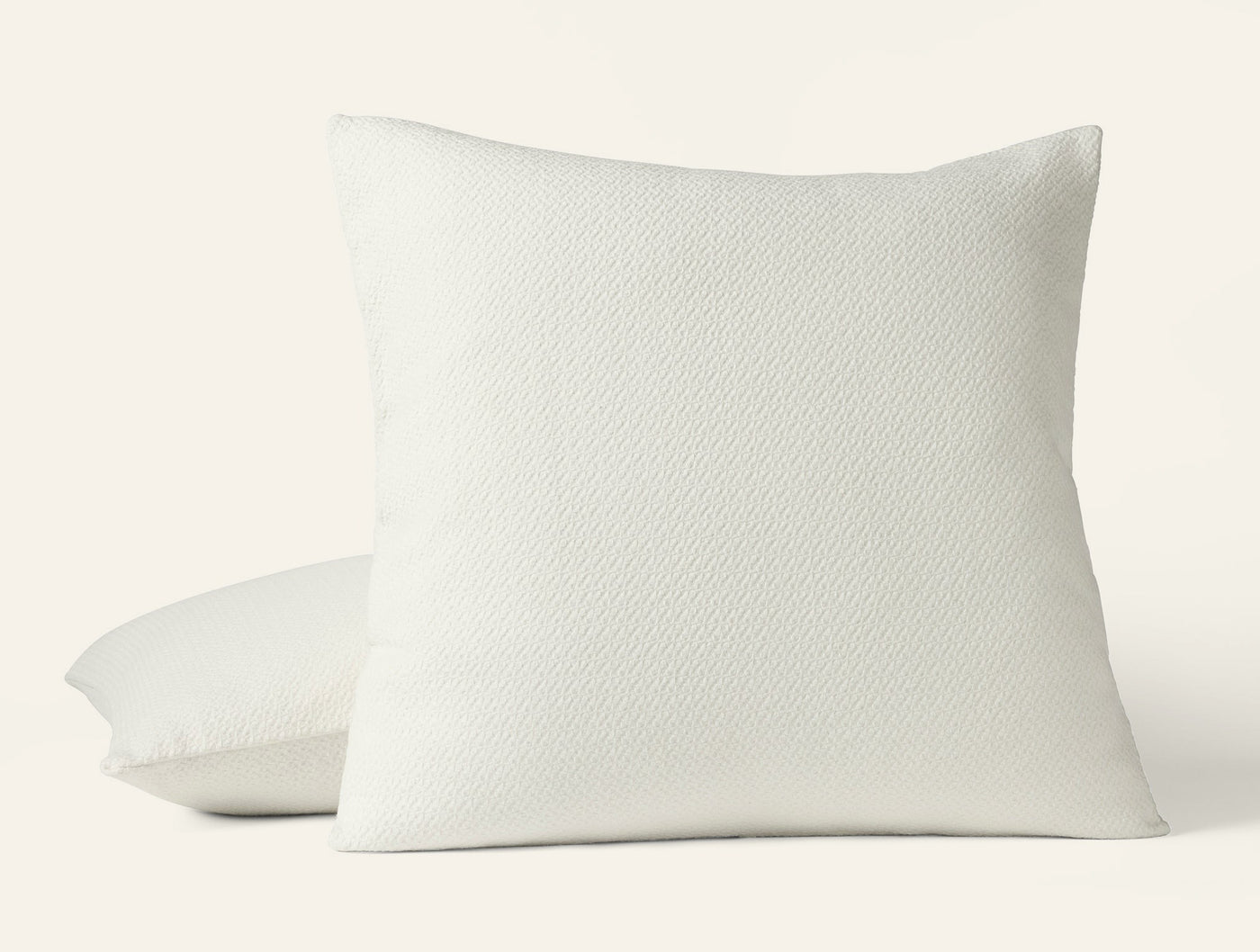 Coyuchi Honeycomb pillow sham in ivory, textured woven pattern, two shams stacked.