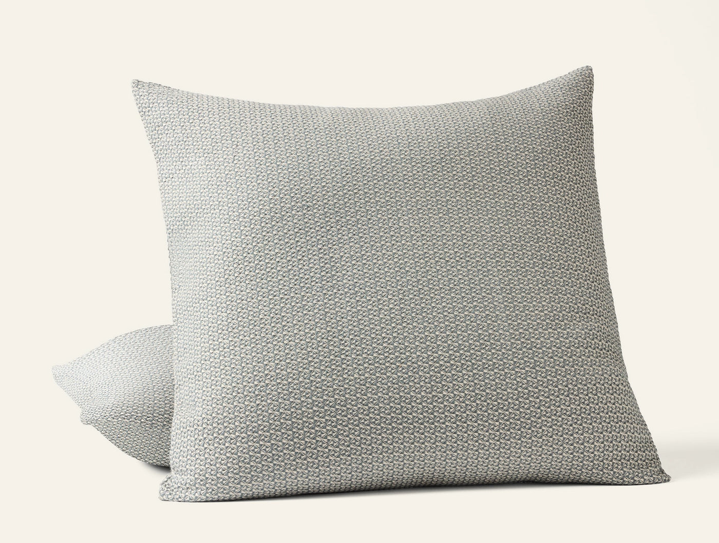 Close-up of Coyuchi Honeycomb sham in silver-grey, showing textured weave pattern on two stacked shams.