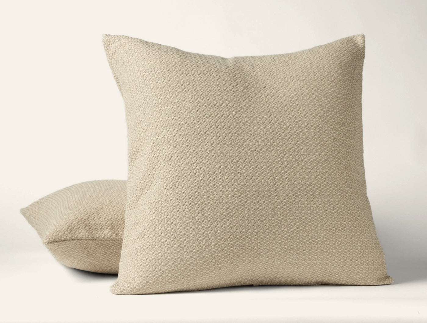 Close-up of Coyuchi Honeycomb sham in natural, showing textured weave pattern on two stacked shams.