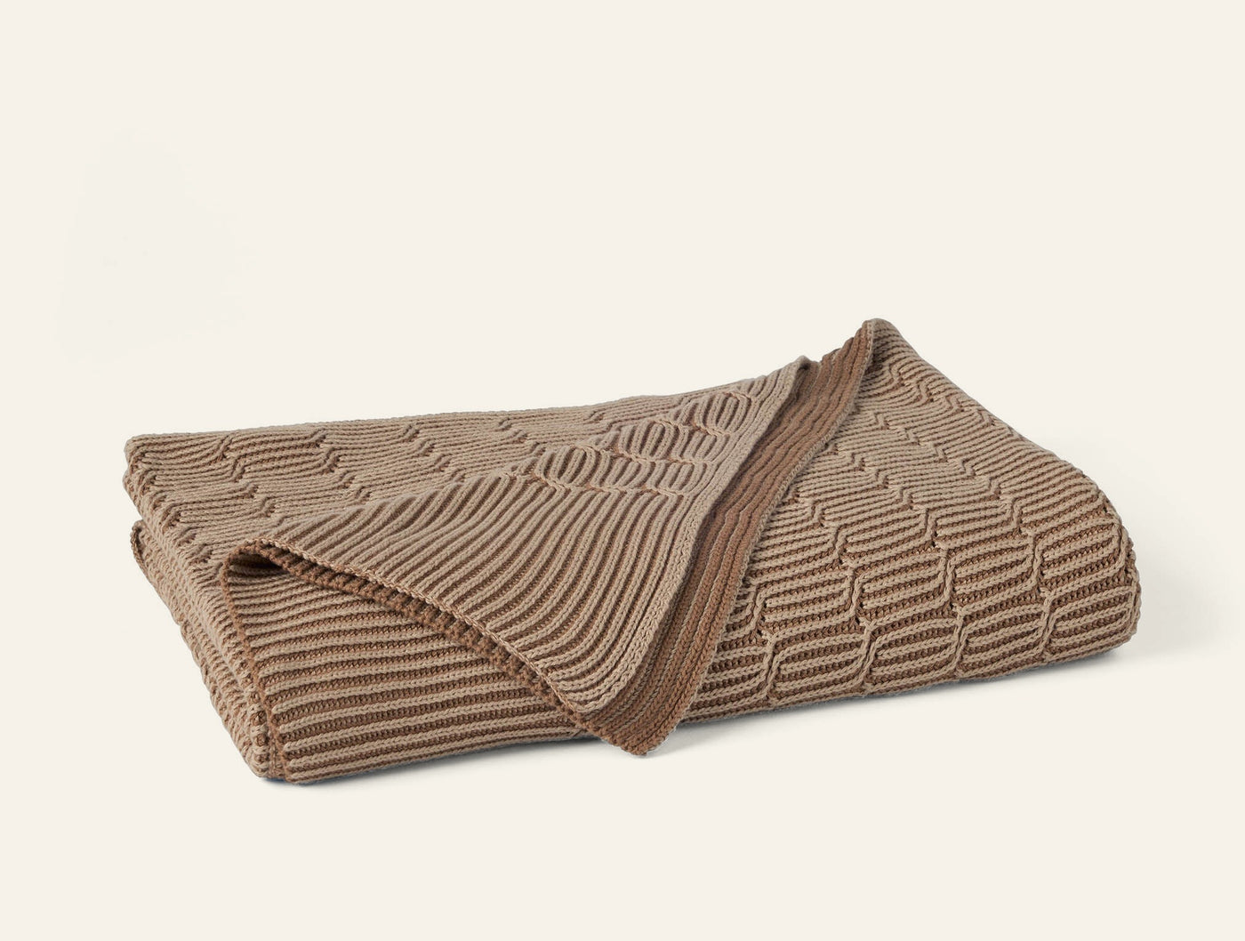 Coyuchi Ivy Knit Throw in taupe, folded to show textured knit pattern.