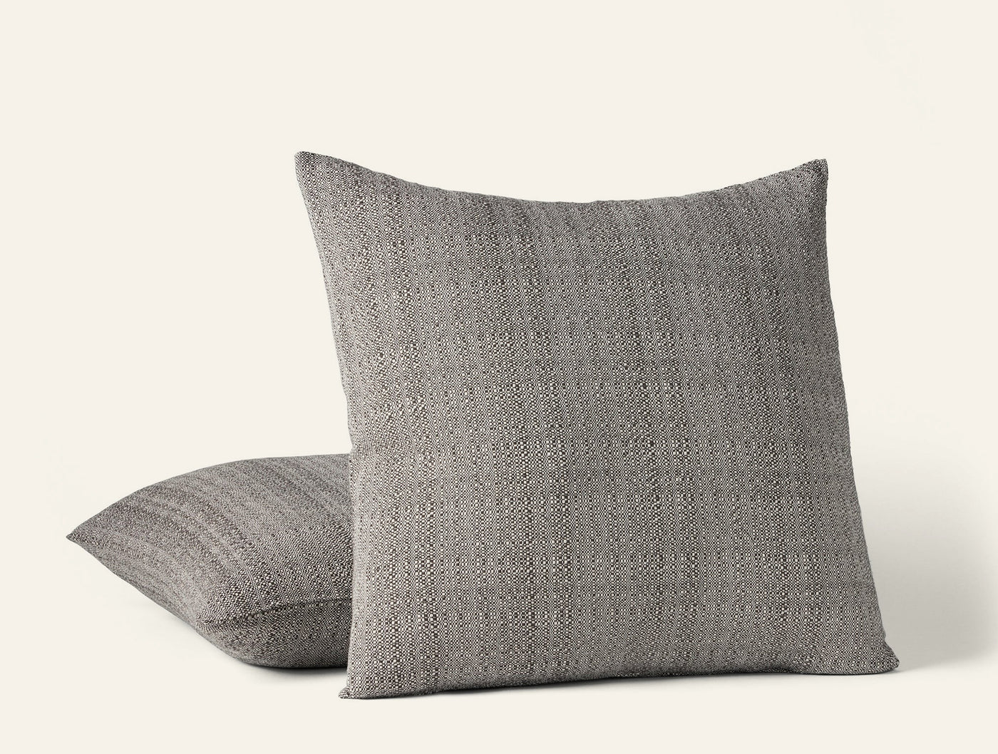 Coyuchi Lido decorative pillow in grey, textured woven fabric, two pillows styled together.