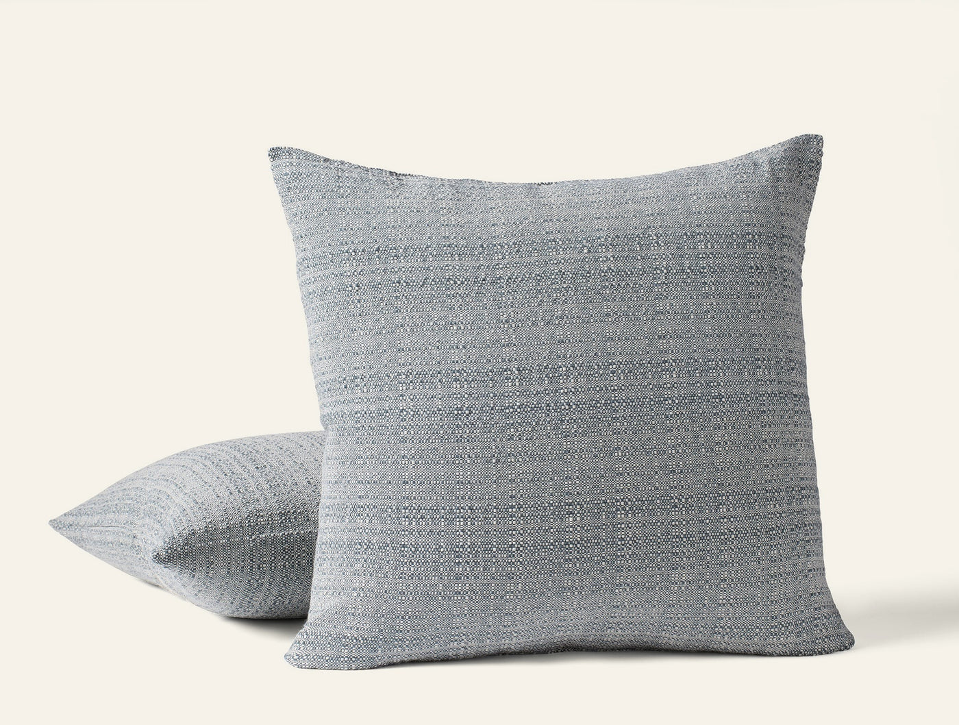 Coyuchi Lido pillows in slate blue, textured woven fabric, two sizes stacked.