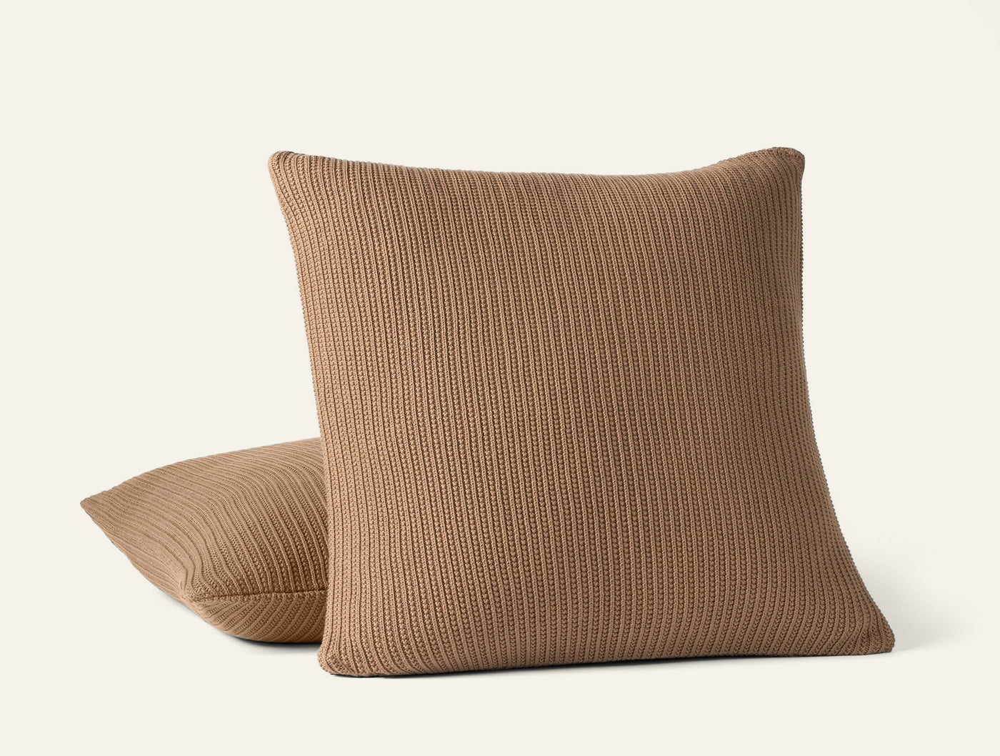 Coyuchi Linea Knit decorative pillow in camel, ribbed knit texture, two pillows stacked.