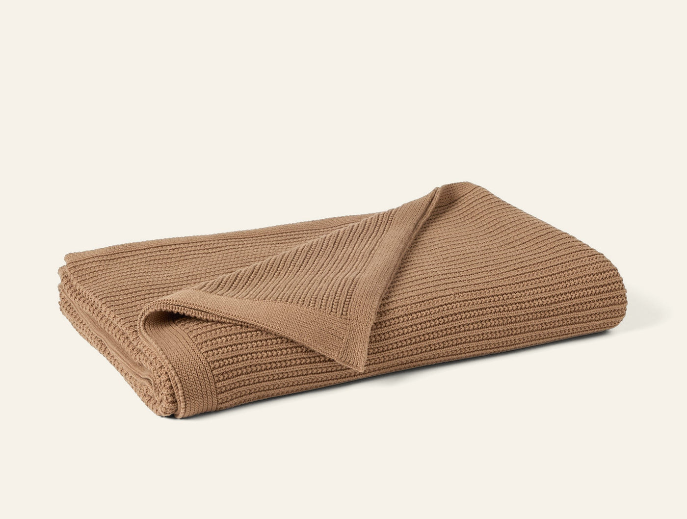 Coyuchi Linea Knit throw in camel, folded to show ribbed knit texture.