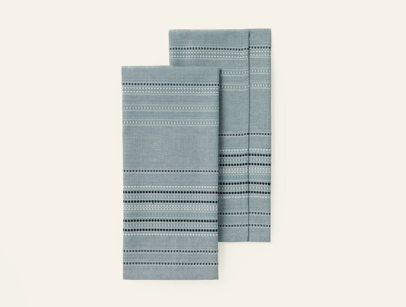 Coyuchi Lobos hand towels in slate, pair folded showing dotted stripe weave detail.