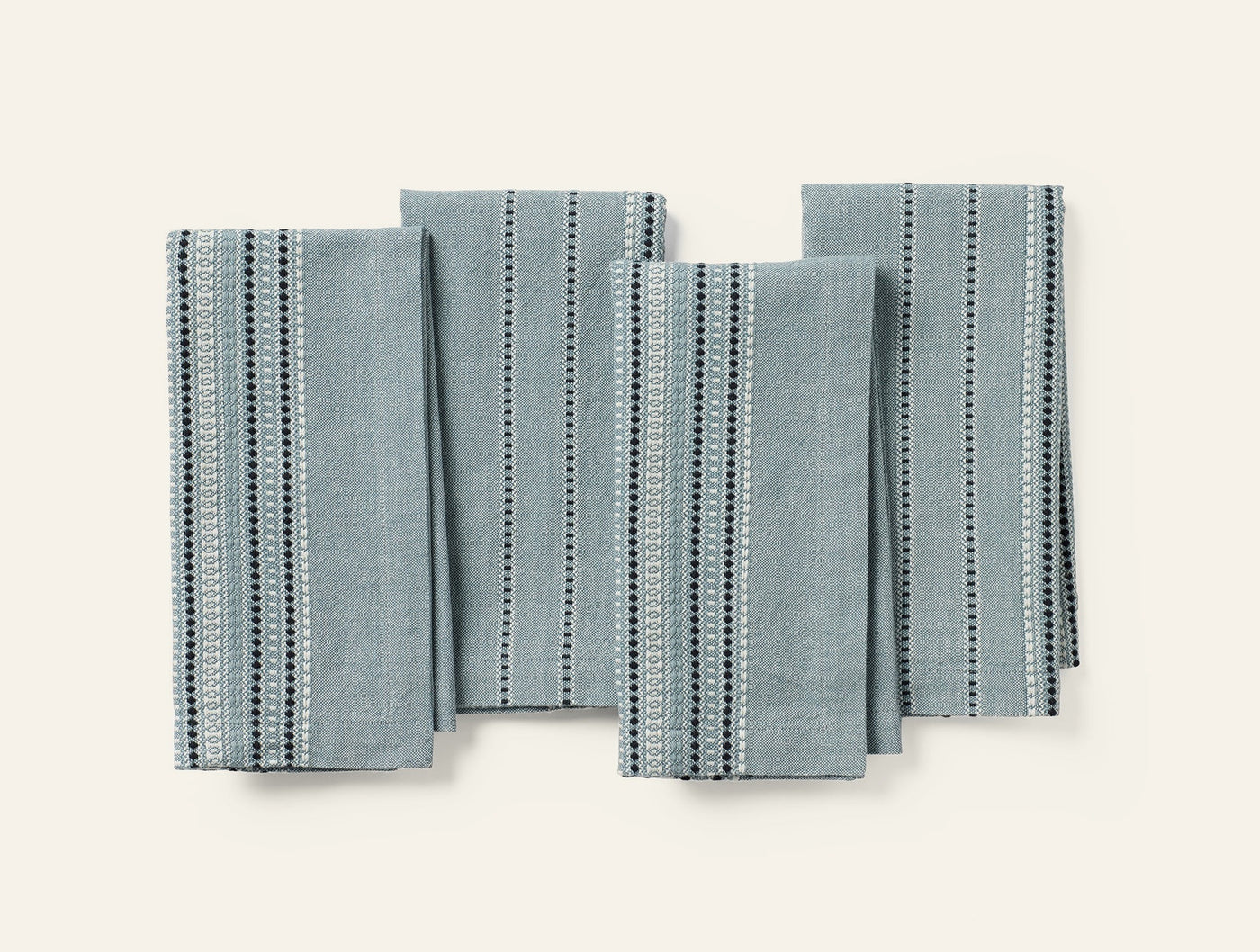 Coyuchi Lobos napkin set of four in sage with dark dotted stripe pattern.