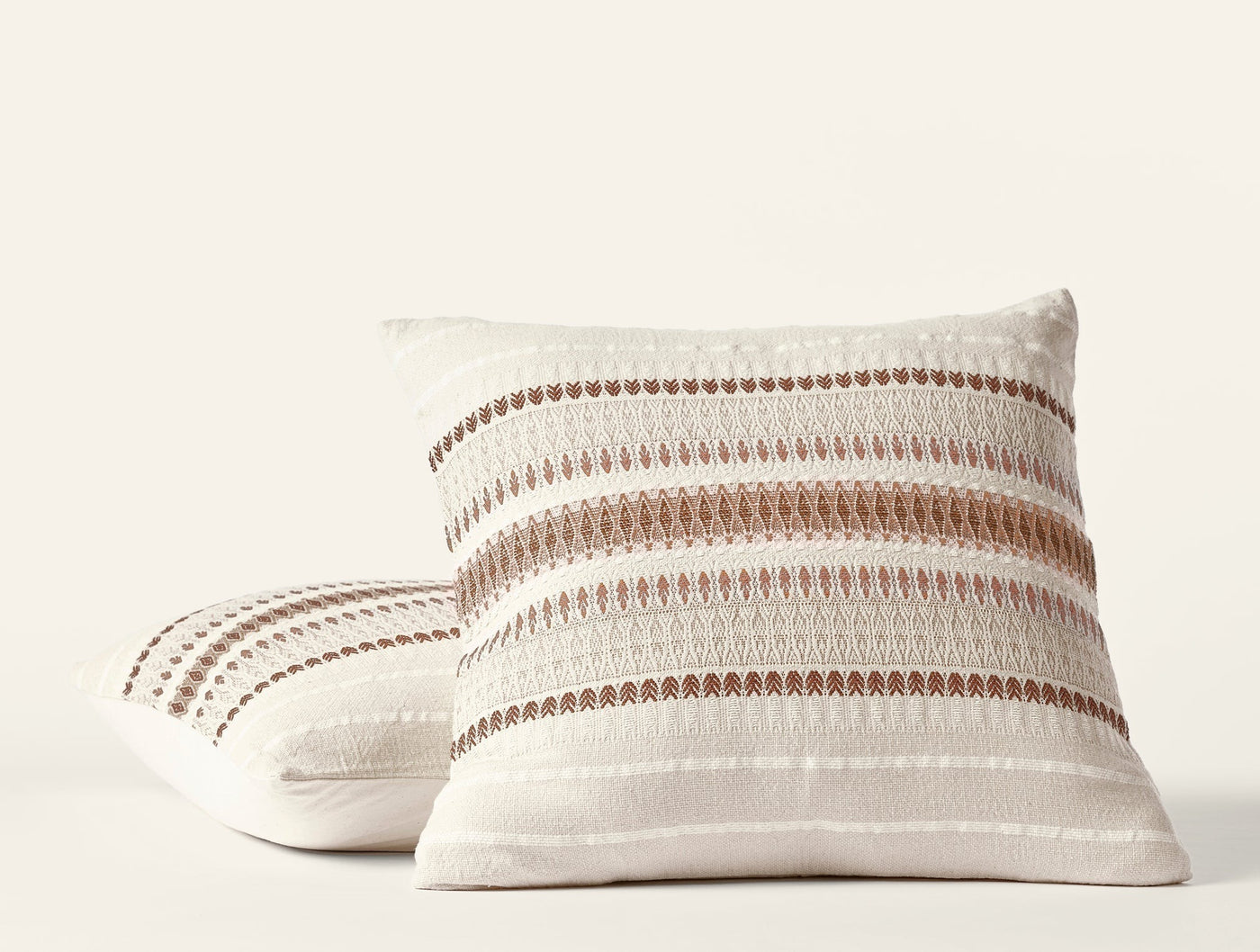 Coyuchi Lost Coast pillow pair, ivory with terracotta stripe embroidery detail.