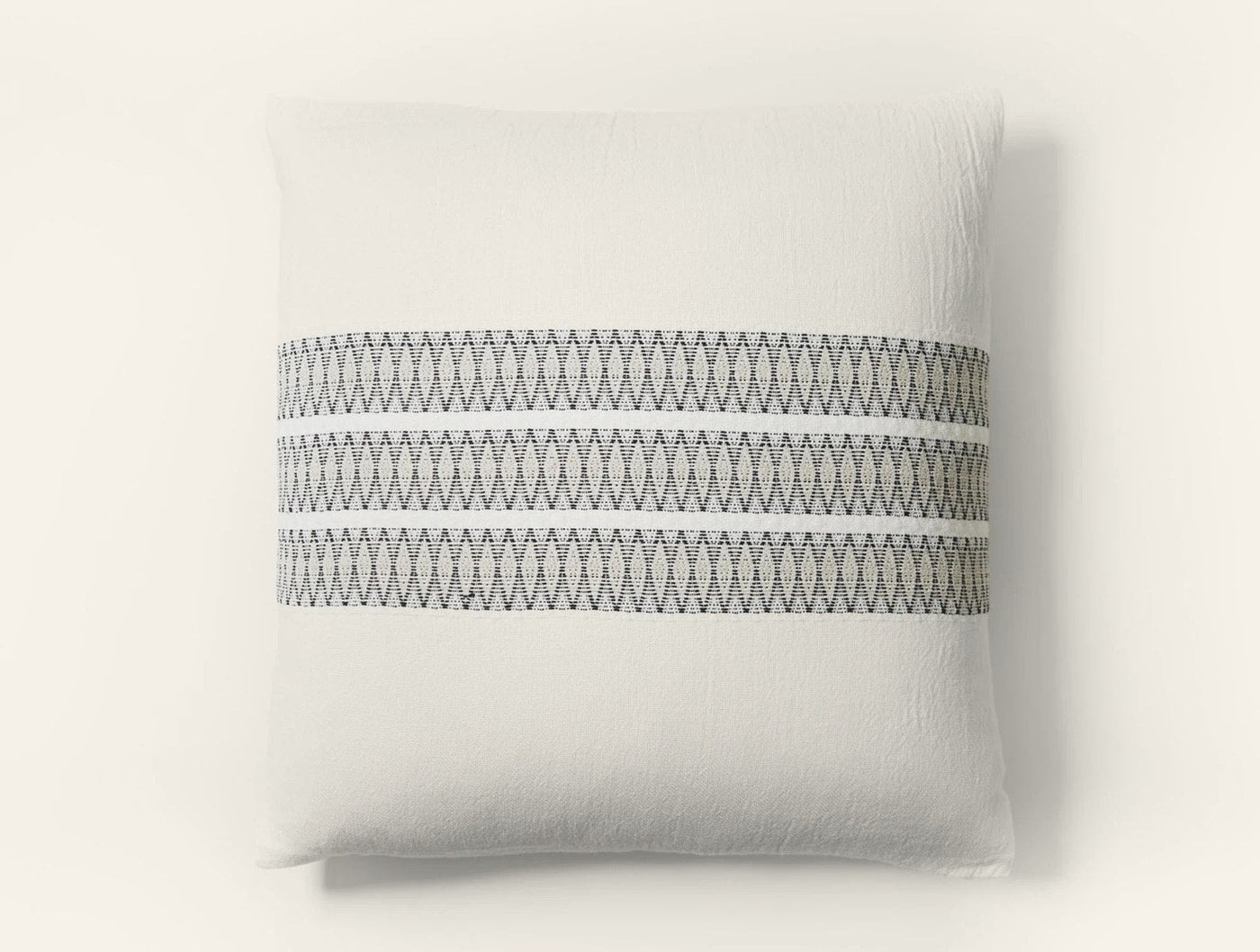 Coyuchi Lost Coast pillow sham in white with charcoal zigzag embroidered stripe detail.